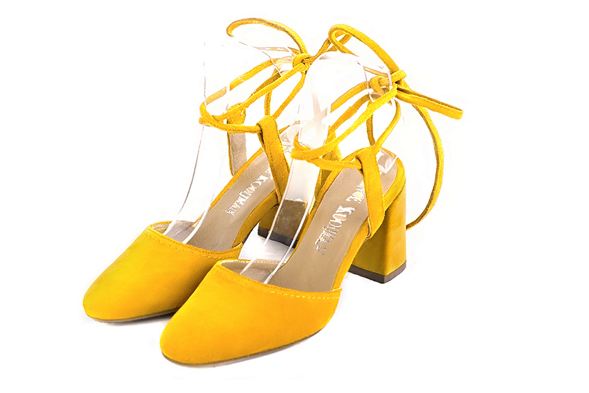 Women's yellow elegant closed-toe heels, with crossed straps. Round toe. High flare heels - Front view